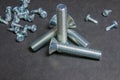 Bolts and Screws on grey. Three bolts intersections