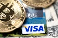 Bitcoin on Visa debit card and one dollar banknotes. Digital money with plastic money. Banknotes Royalty Free Stock Photo