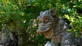 Dragon sculpture attacked by a lion in the sacred wood of Bomarzo. a natural park adorned with numerous basalt sculptures