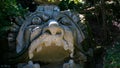 Monstrous sculpture called of Proteus and Glaucus at the Park of the Monsters of Bomarzo among trees and vegetation