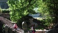 Tourists walking in the Parco dei Mostri in Bomarzo. Natural park adorned with basalt sculptures