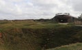 Bomb craters and a building at Pointe du Hoc, France