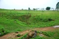 Bomb craters from the Vietnam War surround giant megalithic stone urns at the Plain of Jars archaeological site in Loas.