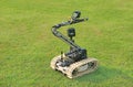 Bomb detection and disposal robot on green grass field