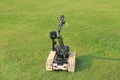 Bomb detection and disposal robot on green grass field