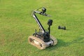Bomb detection and disposal robot on green grass field