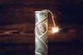 Bomb of money, hundred-dollar bills with a burning fuse. Waiting for the explosion. Concept of the financial crisis Royalty Free Stock Photo