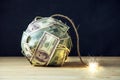 Bomb of money hundred dollar bills with a burning wick. Little time before the explosion. Concept of financial crisis Royalty Free Stock Photo