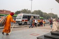 Bomb squad police vehicle parked outside of a Delhi Metro Station as people walk by