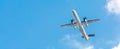 Bombardier Dash Turboprop aircraft in clear blue sky. Passenger Transportation. Aviation. Air business. Free space for text