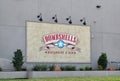 Bombshells restaurant and bar sign on an exterior wall in Houston, TX.