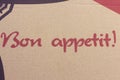 Bon Appetit message french text on carton board.