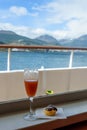 Bon Voyage drink and pastry, looking out over deck and railing from inside cruise ship Royalty Free Stock Photo
