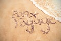 Bon voyage written on sand