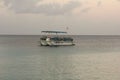 BONAIRE - OCTOBER 6, 2013: Resort dive boat anchored during sunrise Royalty Free Stock Photo