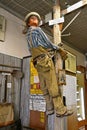 Mannequin lineman climbs a pole