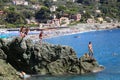 Bonassola, Italy - summer2020: guys dive from a cliff into the sea of the five lands