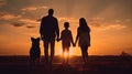 A Bond Beyond Words: Silhouette of a Happy Family with Dog Against the Setting Sun Royalty Free Stock Photo