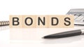 Bond indices on wooden cubes on a white background