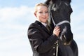 The bond between rider and horse. Low angle portrait of a young female rider hugging her horse affectionately. Royalty Free Stock Photo