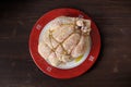 Bondage shibari oiled and spiced raw chicken on red boarder plat