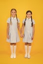 Bonded. small girls in school uniform. retro look. children in vintage style. old school. kid fashion. happy friends on