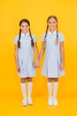Bonded. small girls in school uniform. retro look. children in vintage style. old school. kid fashion. happy friends on