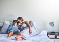 Bonding before the baby comes. Full length shot of an adorable little boy and his pregnant mother using a laptop while Royalty Free Stock Photo