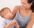 Bonding, bed and mother with baby eating biscuit for yummy, delicious and nutrition snack. Child development, love and