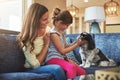 Bonding with the furriest member of their family. a mother and her daughter playing with their dog at home. Royalty Free Stock Photo