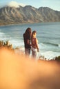 Bonding with my love. an affectionate young couple standing together and looking out at sea during a day outdoors. Royalty Free Stock Photo