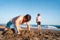 Bonding over beach play, a father and daughter focus intently on constructing a grand sandcastle together Royalty Free Stock Photo