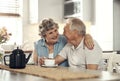 Bonding over a cup of tea. Shot of a senior couple having breakfast together at home. Royalty Free Stock Photo