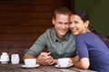 Bonding over a cuppa. a young multi-racial couple enjoying a cup of coffee at a restaurant. Royalty Free Stock Photo