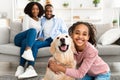 Young black girl hugging with dog posing at home Royalty Free Stock Photo