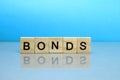 Bonds word made of wooden blocks on a blue background