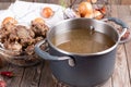 Bone Broth Bouillon in Metal saucepan on the wooden table  paleo diet Royalty Free Stock Photo