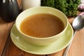 Bone broth made from beef, served in a green soup bowl