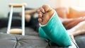 Bone fracture foot and leg on male patient with splint cast and crutches during surgery rehabilitation and orthopaedic recovery Royalty Free Stock Photo