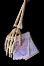 Bone hand with money Royalty Free Stock Photo