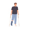 Bone injury or fracture of young patient. Man walking with crutches and gypsum on broken leg. Rehabilitation and