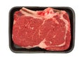 Bone in rib eye steak on black butcher tray Royalty Free Stock Photo