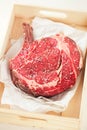 Bone-in Rib eye Steak steak on paper Royalty Free Stock Photo