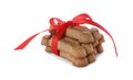 Bone shaped dog cookies with red bow isolated on white Royalty Free Stock Photo