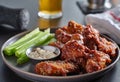 Boneless bbq chicken wings with beer glass in background