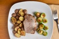 boneless pock chop with sauteed brussel sprouts and potatoes