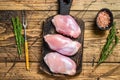 Boneless Raw Chicken thigh fillet. Wooden background. Top view