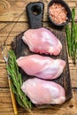 Boneless Raw Chicken thigh fillet. Wooden background. Top view Royalty Free Stock Photo