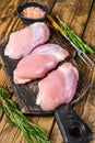 Boneless Raw Chicken thigh fillet. Wooden background. Top view Royalty Free Stock Photo