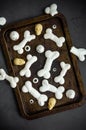 Bones Halloween Meringues with ghosts, chocolate skulls and eyes on an old baking sheet on a dark background. Royalty Free Stock Photo